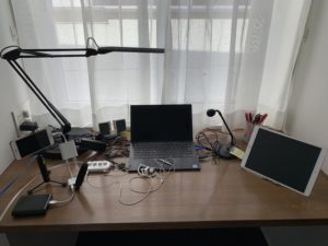 remote interpreting setting with PC, iPad and iPhone with microphones and LAN cables connected